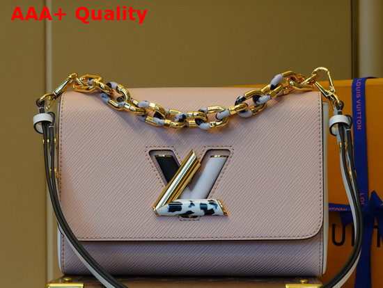 Louis Vuitton Twist MM Handbag in Pink Epi Grained Leather Features a LV Twist Lock Decorated with Tortoise Shell and Black and White Stones Replica